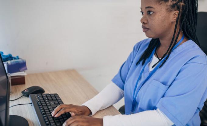 Nurse typing on a computer