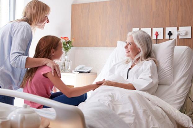 Patient with daughter and child visiting bedside.