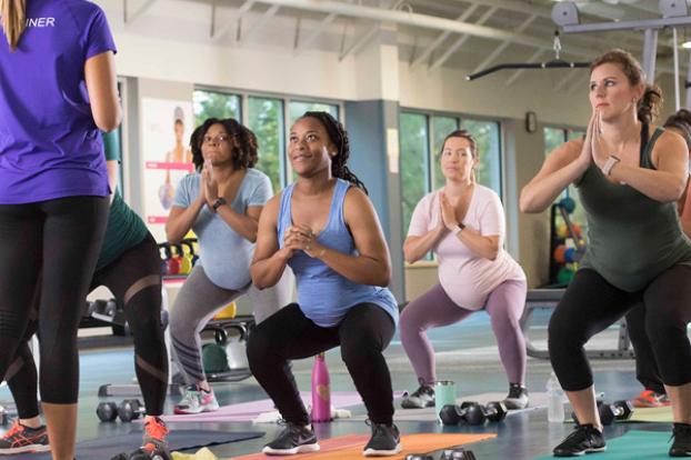 Prenatal fitness exercise class squats.