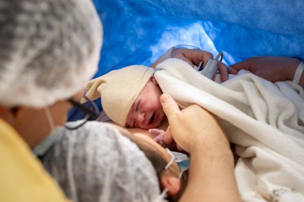 Family with newly delivered infant by C-section