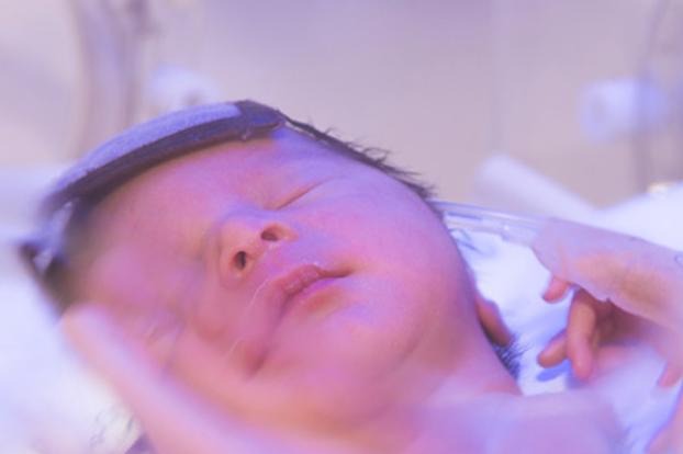 Newborn face in incubator