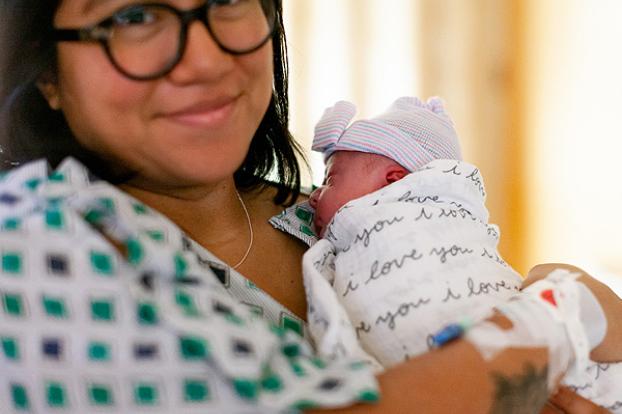 Mom and swaddled infant in hospital.
